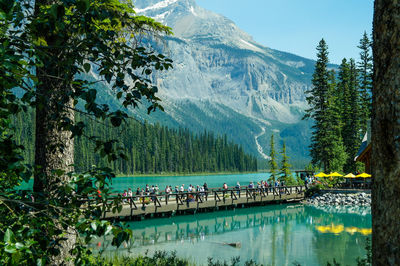 Group of people by swimming pool in lake