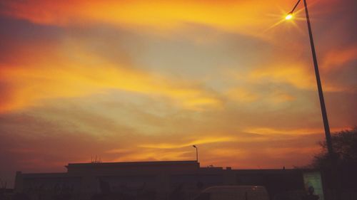 Low angle view of city against sky during sunset