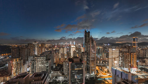 High angle view of illuminated buildings against sky at night