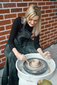 High angle view of woman making pottery