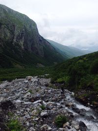 Scenic view of river and mountains against sky