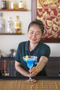 Female bartender preparing drink bar