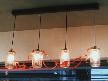 Low angle view of illuminated lamp at night