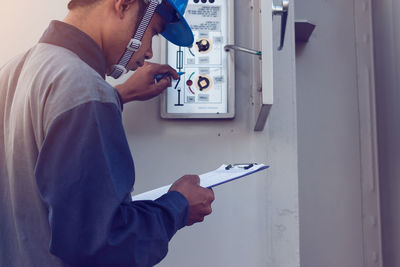 Male engineer checking meter