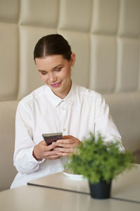 Young woman using mobile phone