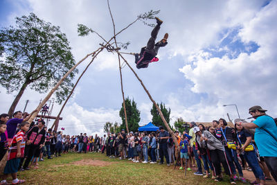 Group of people in traditional windmill against sky