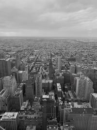 Aerial view of buildings in city against sky