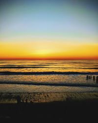 Scenic view of sea against clear sky during sunset