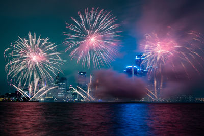 Low angle view of firework display at night