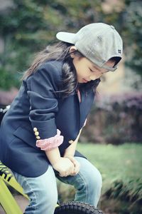 Low section of girl sitting in park