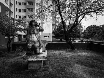 Statue in park against building