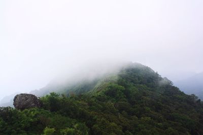 Scenic view of mountains against cloudy sky