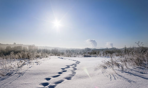 Snow covered field against sky