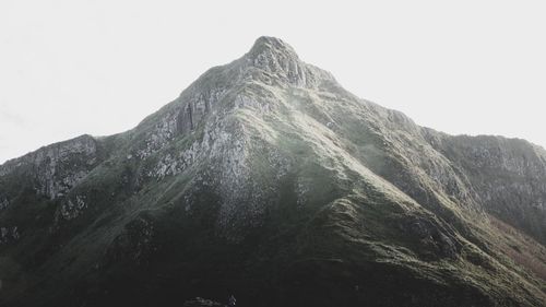 Low angle view of mountain range against clear sky