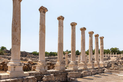 Low angle view of columns against clear sky