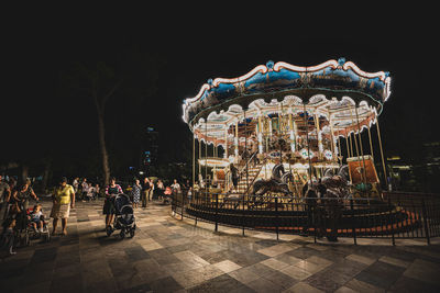 Illuminated amusement park ride at night