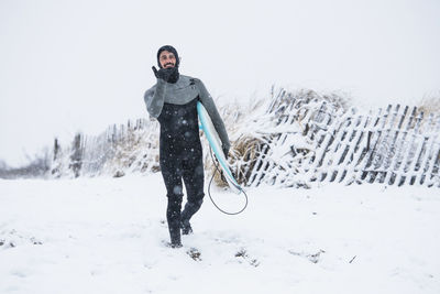 Man going surfing during winter snow