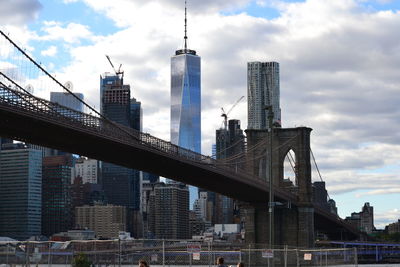 Modern buildings in city against cloudy sky