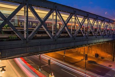 Light trails on bridge in city at night