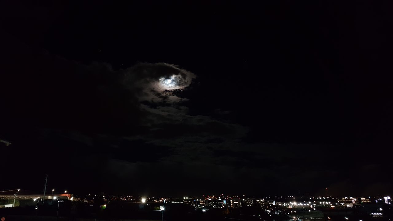 ILLUMINATED CITY AGAINST SKY AT NIGHT