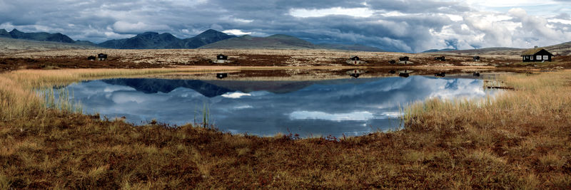 Scenic view of lake and mountains against sky