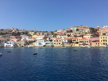 Scenic view of residential district against clear blue sky