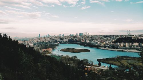 High angle view of river and buildings against sky