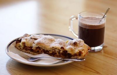 Close-up of hot chocolate and cake on table