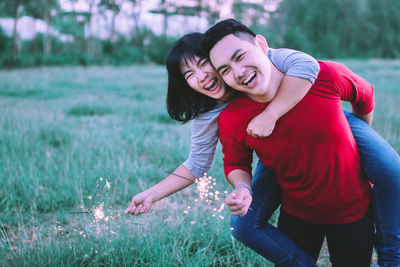 Young couple kissing on field