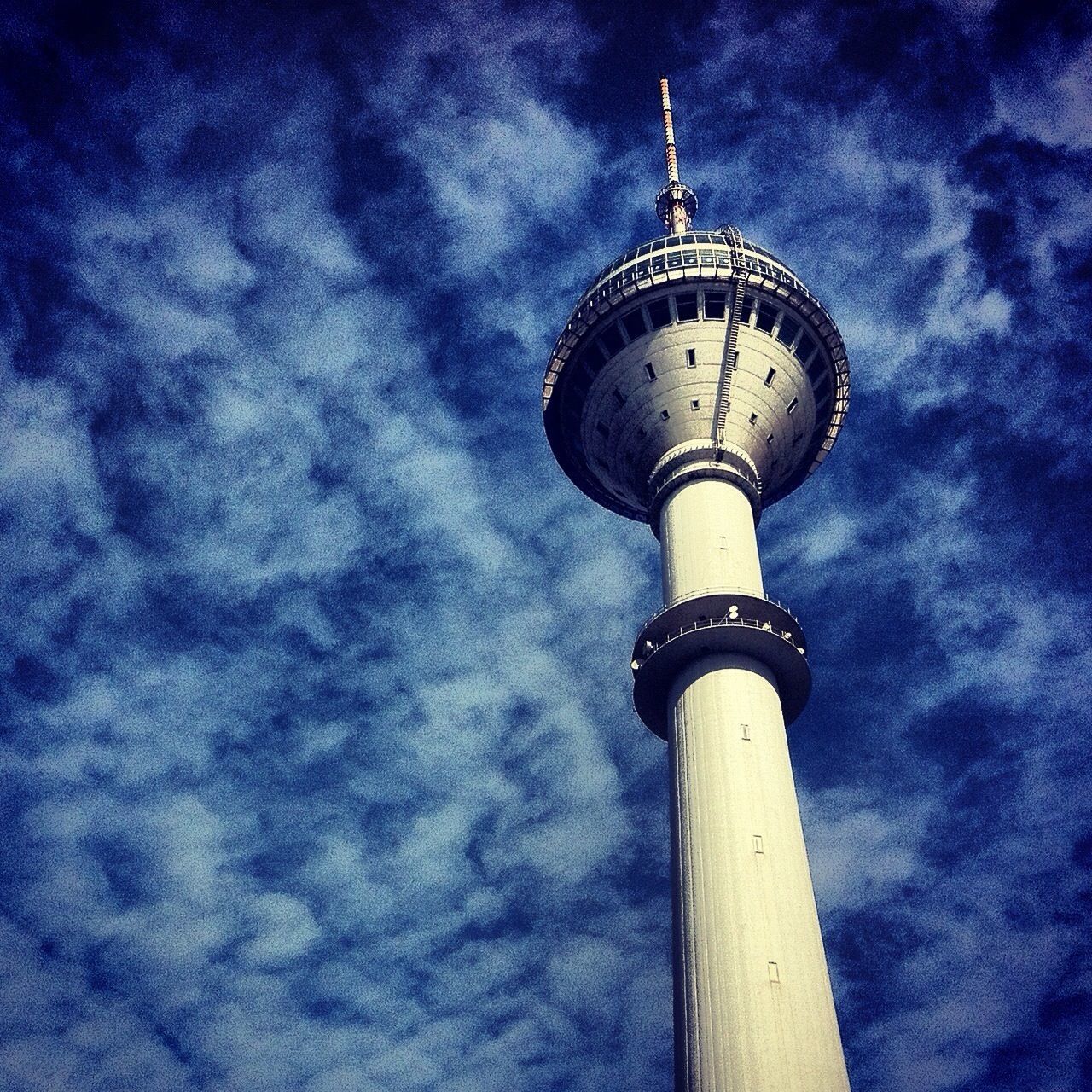 tower, low angle view, architecture, communications tower, built structure, tall - high, communication, international landmark, sky, building exterior, travel destinations, tourism, capital cities, famous place, travel, culture, television tower, cloud - sky, fernsehturm, spire