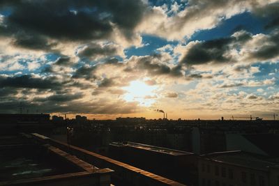 View of cityscape against cloudy sky