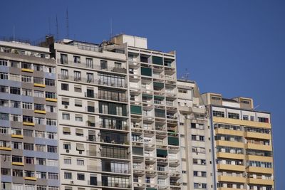 Low angle view of building against clear blue sky