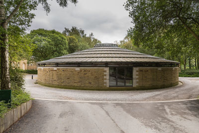 Road by building against sky