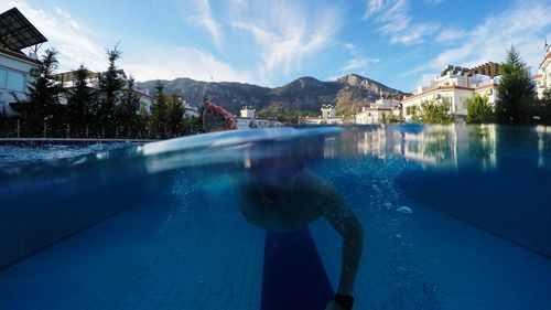 Water surface shot of man swimming in pool