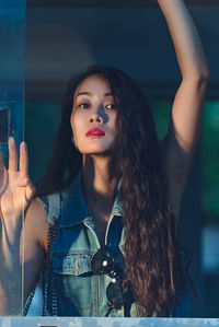 Portrait of young woman looking away while sitting in car