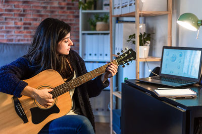 Young woman playing guitar