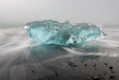 Ice on black sand beach in south iceland