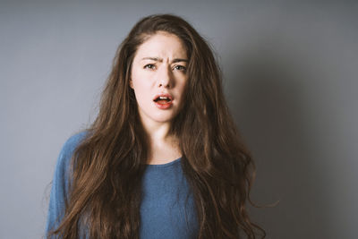 Portrait of teenage girl against white background