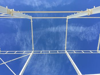 Low angle view of vapor trail against blue sky