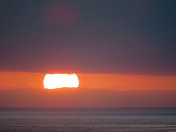 Scenic view of sea against romantic sky at sunset