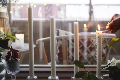 Hand of person lighting candles