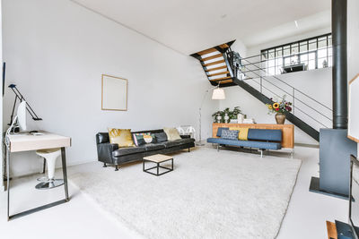 Empty chairs and tables against wall at home