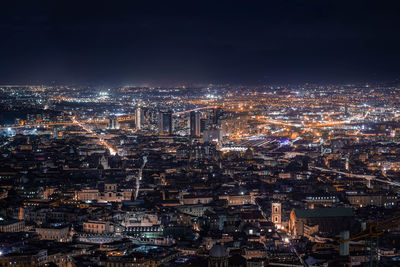 High angle view of illuminated city buildings at night