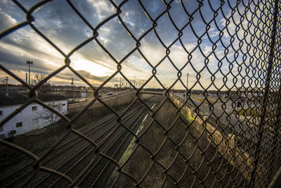 Scenic view of train seen through chainlink fence