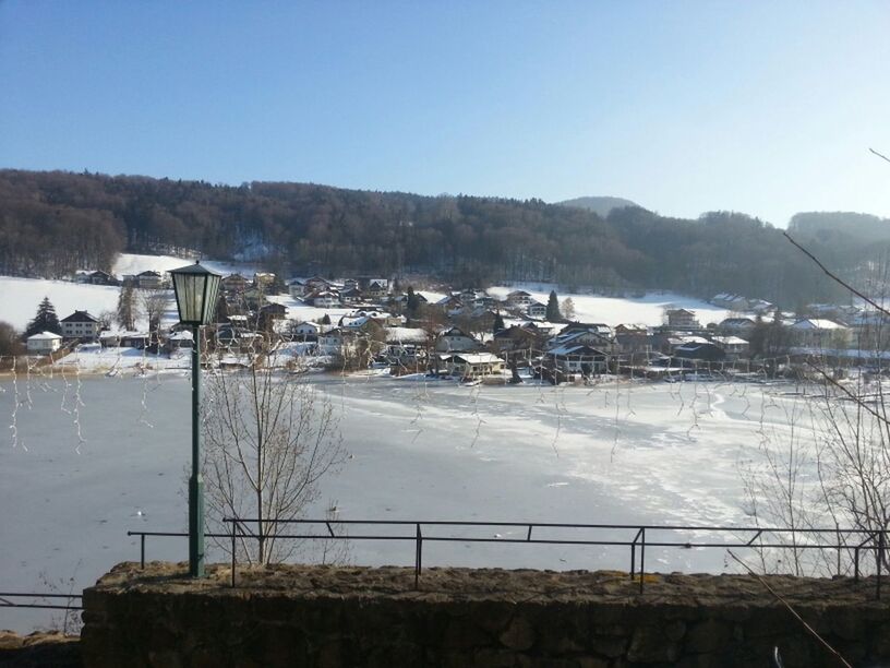 snow, winter, cold temperature, mountain, clear sky, built structure, architecture, building exterior, house, season, landscape, nature, copy space, sky, mountain range, fence, tranquil scene, tranquility, residential structure, weather