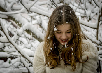 Close-up of smiling girl in snow