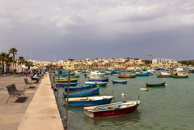 Boats moored at harbor