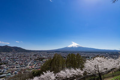 Scenic view of snowcapped mountain against blue sky