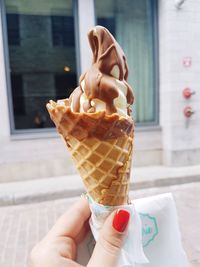 Hand holding ice cream cone