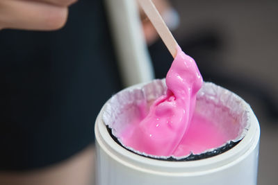 Wax in heating container. the cosmetologist uses hot wax for depilation and prepares it in a special